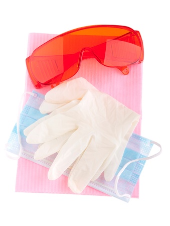 health and safety equipment (glasses, gloves, mask and bib) to prevent cross infection (isolated on white)の写真素材