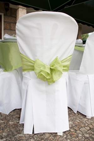 gorgeous wedding chair decorated with a green ribbon at outdoorsの写真素材