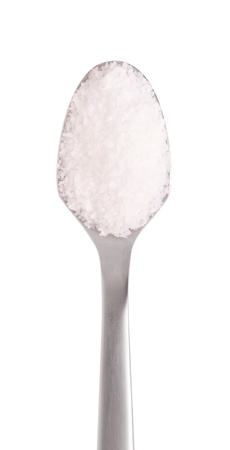 salt spice on a stainless steel spoon, isolated on white backgroundの写真素材