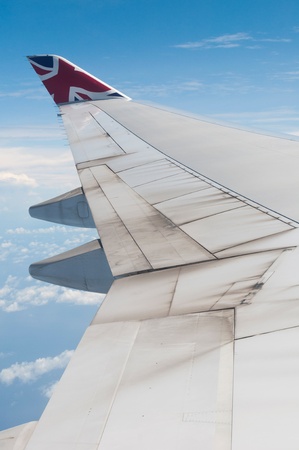 ST JOHNS, ANTIGUA - AUGUST 17: view of Boeing 747 wing of Virgin Atlantic Airways with blue sky clouds close to V. C. Bird International Airport in Antigua on August 17, 2011 in St. Johnのeditorial素材
