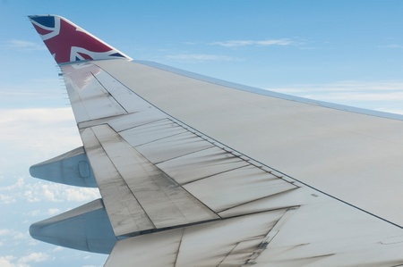 ST JOHNS, ANTIGUA - AUGUST 17: view of Boeing 747 wing of Virgin Atlantic Airways with blue sky clouds close to V. C. Bird International Airport in Antigua on August 17, 2011 in St. Johnのeditorial素材