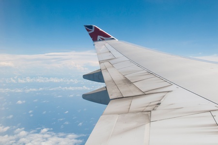 ST JOHNS, ANTIGUA - AUGUST 17: view of Boeing 747 wing of Virgin Atlantic Airways with blue sky clouds close to V. C. Bird International Airport in Antigua on August 17, 2011 in St. Johnのeditorial素材