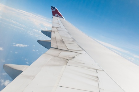 ST JOHNS, ANTIGUA - AUGUST 17: view of Boeing 747 wing of Virgin Atlantic Airways with blue sky clouds close to V. C. Bird International Airport in Antigua on August 17, 2011 in St. Johnのeditorial素材