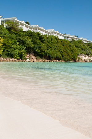 tropical beach and resort villas along the coast in Long Bay, Antiguaの写真素材