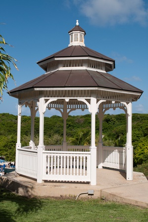white gazebo on a tropical park with pathway (blue sky background)の写真素材