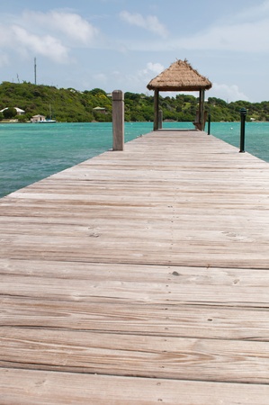 tropical wooden jetty with hut over sea in Long Bay, Antiguaの写真素材