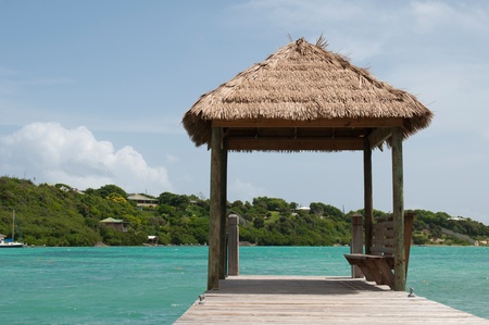 tropical wooden jetty with hut over sea in Long Bay, Antiguaの写真素材