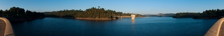 stunning view of river Zezere and Castelo de Bode Dam in Tomar, Portugal (panoramic picture with gorgeous blue sky)の写真素材