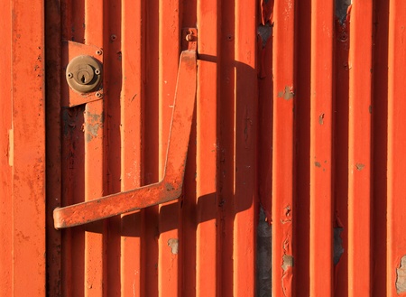 vibrant orange rusty iron door as a background or textureの写真素材