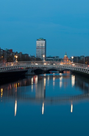 stunning nightscene with Ha'penny bridge and Liffey river, the Custom House landmark at the background (picture taken after sunset)の写真素材