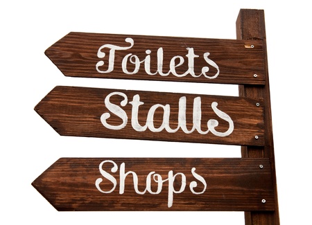 wooden signage indicating toilets, stalls and shopping area (isolated on white background)の写真素材