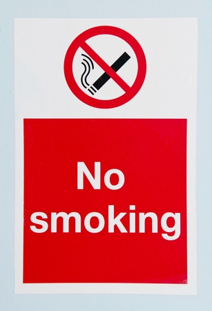no smoking sign against a blue wall backgroundの写真素材