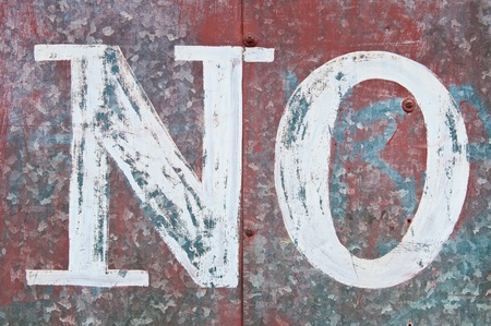 vintage word NO on a rusty red metallic surfaceの写真素材