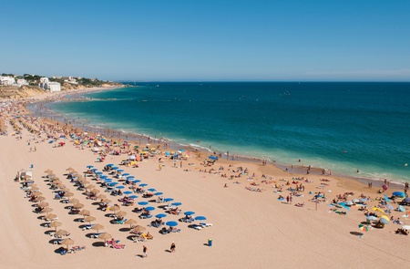 ALBUFEIRA, PORTUGAL - AUGUST 30: tourists and locals enjoying a sunny day at the beach in Algarve on August 30, 2011 in Albufeira, Portugal. It is the most touristic place in the region during all year.のeditorial素材