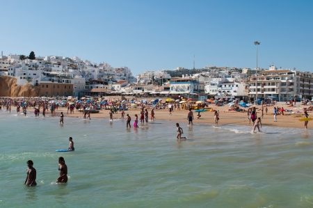 ALBUFEIRA, PORTUGAL - AUGUST 29: tourists and locals enjoying a sunny day at the beach in Algarve on August 29, 2011 in Albufeira, Portugal. It is the most touristic place in the region during all year.のeditorial素材