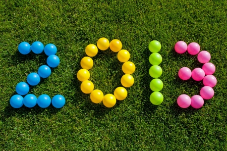 Happy New Year 2013 against a green grass backgroundの写真素材