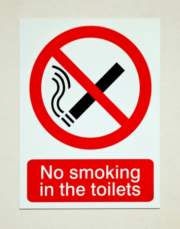 no smoking in the toilets sign on white wallの写真素材