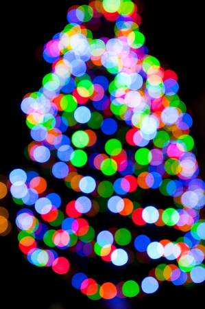 blurred christmas tree lights on a black backgroundの写真素材