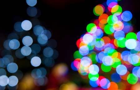 two blurred christmas tree lights on a black backgroundの写真素材