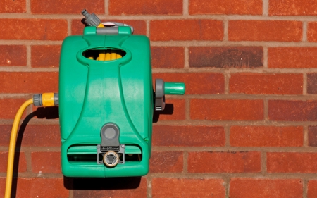 garden hose reel kit installed on a brick wall  copy-space available の写真素材