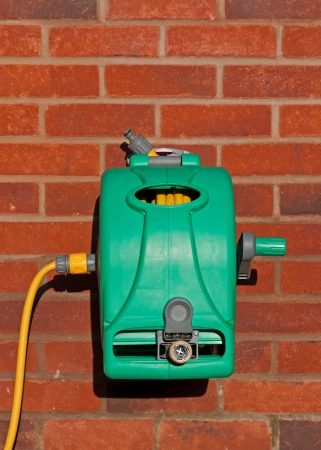 garden hose reel kit installed on a brick wall  copy-space available の写真素材