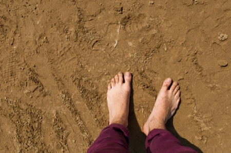 young man barefoot on a beach in Weston-super-Mare, United Kingdomの写真素材