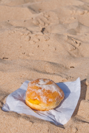 berliner ball on a sandy beach in Algarve, Portugal  traditionally sold during all summer の写真素材