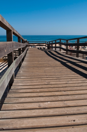 stunning wooden walkway on a sandy beach in Manta Rota  Algarve , Portugalの写真素材