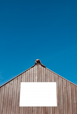squared billboard on wooden structure  isolated on white  against a blue sky backgroundの写真素材