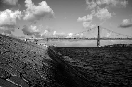 dramatic sunset view of old Salazar bridge, now known as April 25th in Lisbon, Portugal (black and white)の写真素材