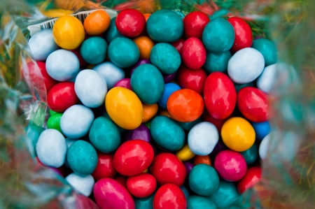 loads of colorful chocolates candies inside a plastic bagの写真素材