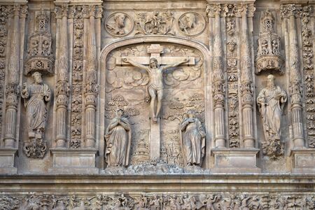 Low relief of Calvary or the Jesus Christ crucifixion on the facade of the San Esteban Convent of Salamanca, Spain; work of Juan Antonio Ceroni in the 17th centuryの写真素材