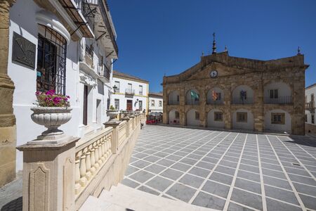 View of Cortes de la Frontera, one of the villages of the Sierra de Grazalema Natural Park. Carlos III Square with the town hall in the backgroundの写真素材