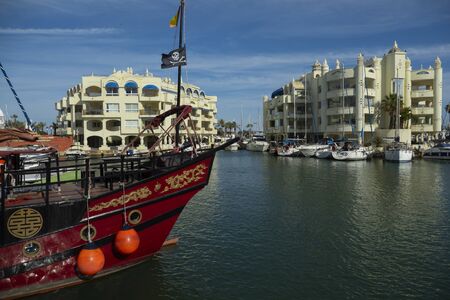 Benalmadena, SPAIN - JUNE 19, 2019: Puerto de BenalmÃ¡dena, Spain. View of the harbor with a picturesque ship in the foreground and the buildings in the backgroundのeditorial素材