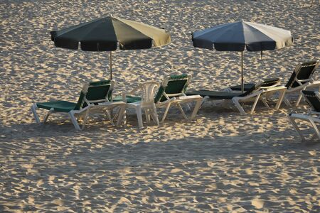 Umbrellas and empty sunbeds on Silgar beach in Sanxenxo at late afternoon. One of the most important and well-known summer places in Galiciaのeditorial素材