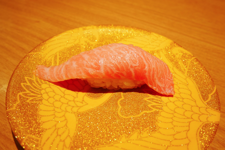 Close up of otoro tuna sushi nigiri on plate in sushi belt cheap price japanese restaurant.の写真素材