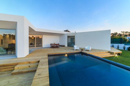 Modern house with garden swimming pool and wooden deckの写真素材