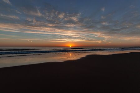 Beautiful sunset on the Carcavelos beach, Cascais, Lisbon, Portugalの写真素材