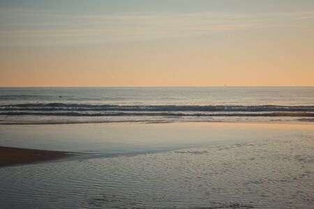 Beautiful sunset on the Carcavelos beach, Cascais, Lisbon, Portugalの写真素材