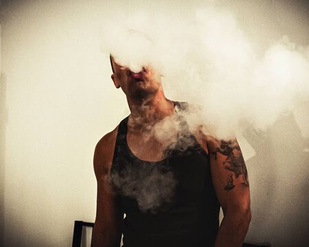 A man smoking an electronic cigarette, vapeの写真素材
