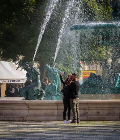 A couple taking a picture on the Rossio square in Lisbon, Portugalのeditorial素材