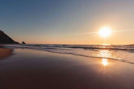 Beautiful sunset on the Adraga beach, Sintra, Lisbon, Portugalの写真素材
