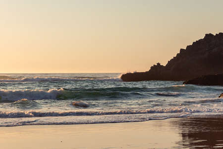 Beautiful sunset on the Adraga beach, Sintra, Lisbon, Portugalの写真素材