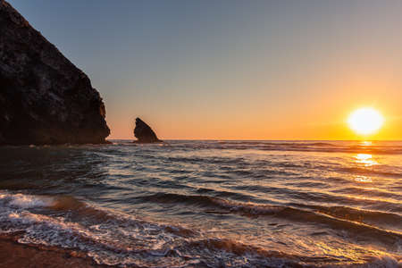 Beautiful sunset on the Adraga beach, Sintra, Lisbon, Portugalの写真素材
