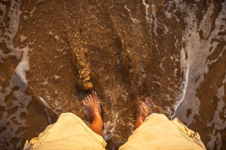 A barefoot man on the beach, sintra, portugalの写真素材