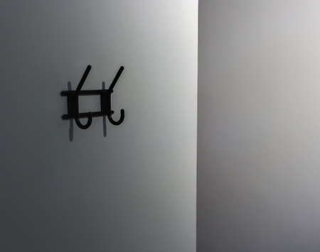 Minimalist photo, a white wall with a hangerの写真素材