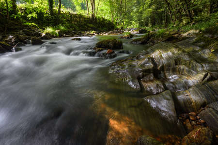 Striated limestone rock in the bed of a river, in Baralla, Galicia