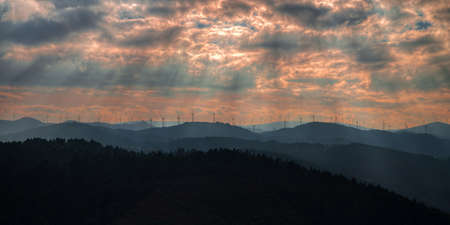 Cloudy sunset over the windmills in the mountains of CadramÃ³n in Ferreira de Valadouro, Lugo, Galiciaの写真素材