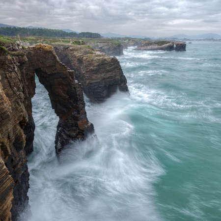 Large waves hit the arches of As Catedrais beach, Ribadeo, Lugo, Galiciaの写真素材