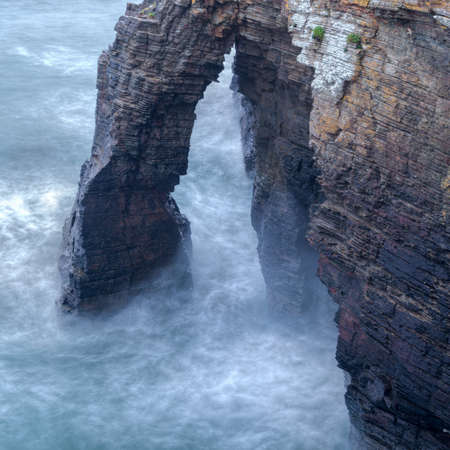 High tide and big waves between the stone arches of the beach of As Catedrais, Ribadeo Lugo, Galicia